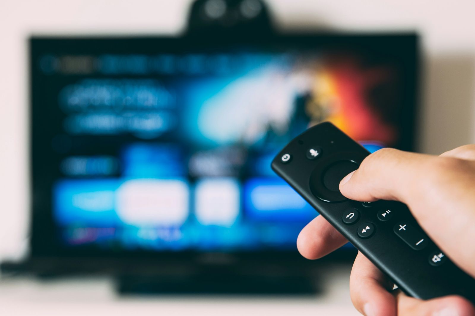 Person browsing streaming services with a TV remote
